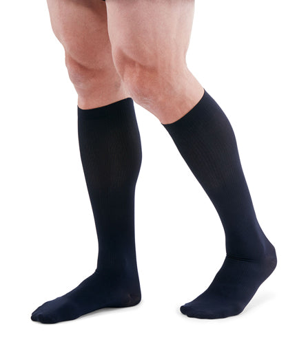 man wearing a pair of navy knee-high compression socks the Mediven for Men Classic sock has a thin verticle pinstripe design